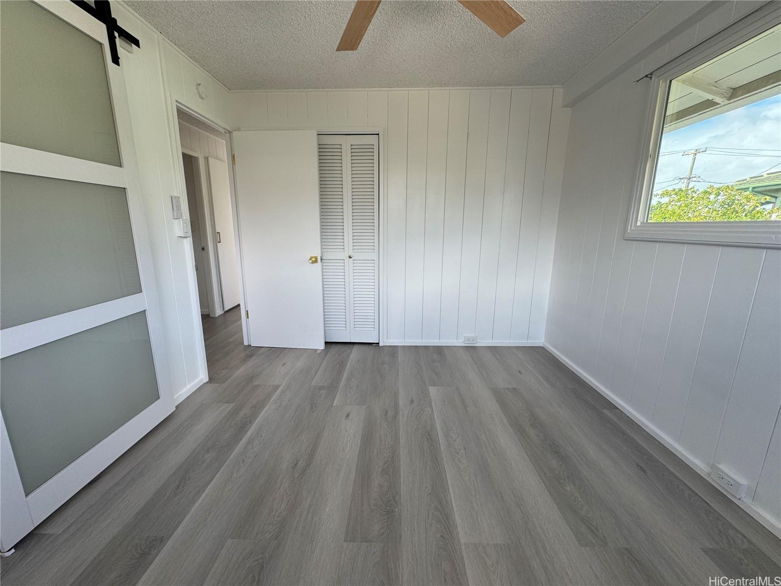 2326 Rose Street Honolulu, HI 96819 - Photo 13 of 19 an empty room with wooden floor and windows