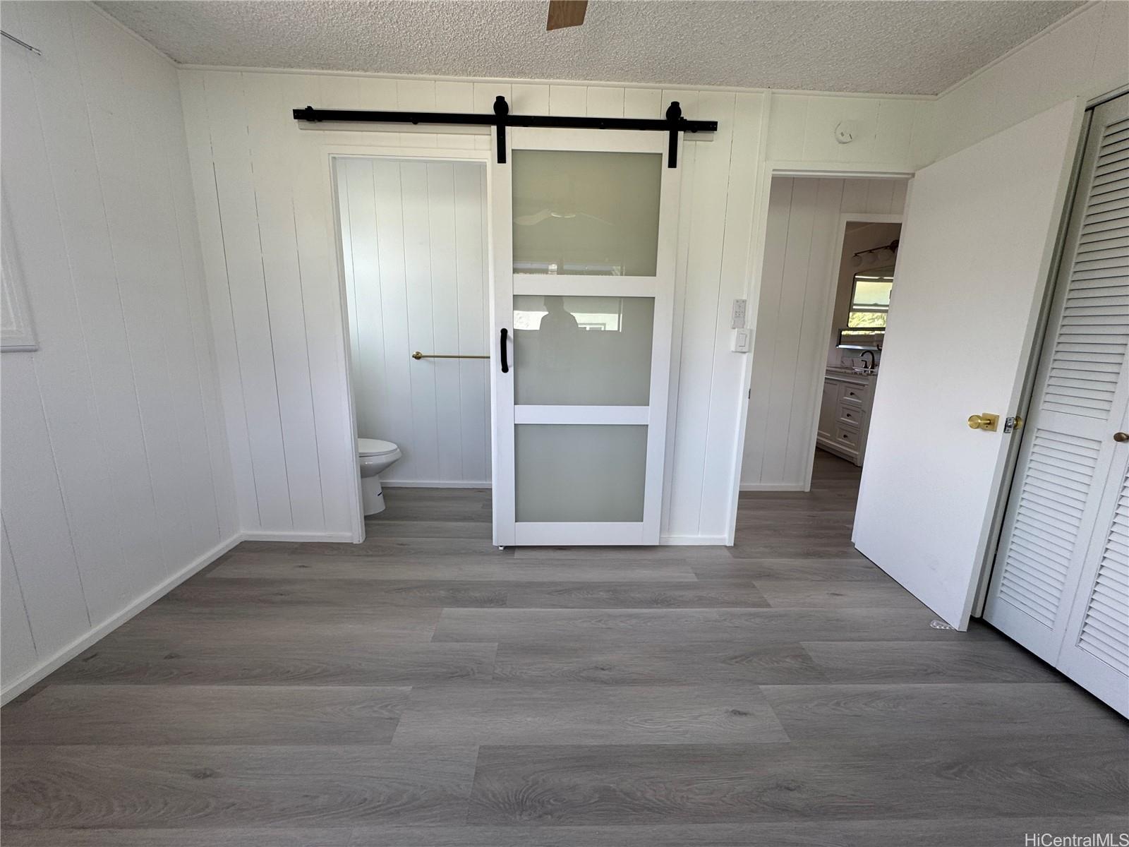 2326 Rose Street Honolulu, HI 96819 - Photo 14 of 19 a view of an empty room with wooden floor and a bathroom