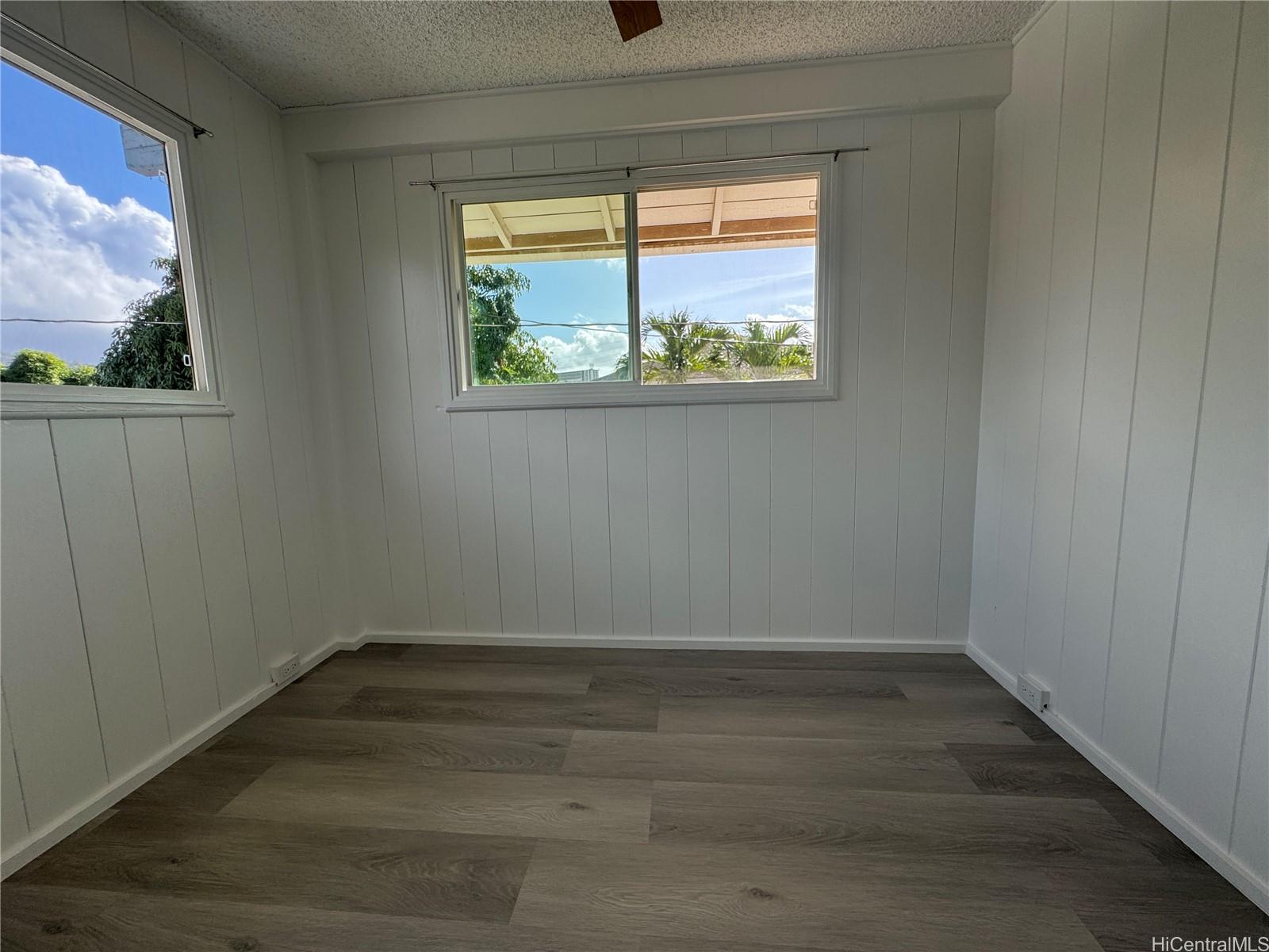 2326 Rose Street Honolulu, HI 96819 - Photo 17 of 19 a view of an empty room with wooden floor and a window