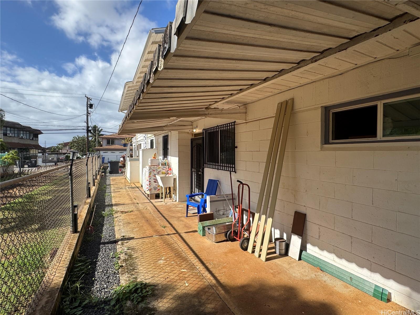 2326 Rose Street Honolulu, HI 96819 - Photo 6 of 19 a view of a patio with table and chairs with wooden floor and fence