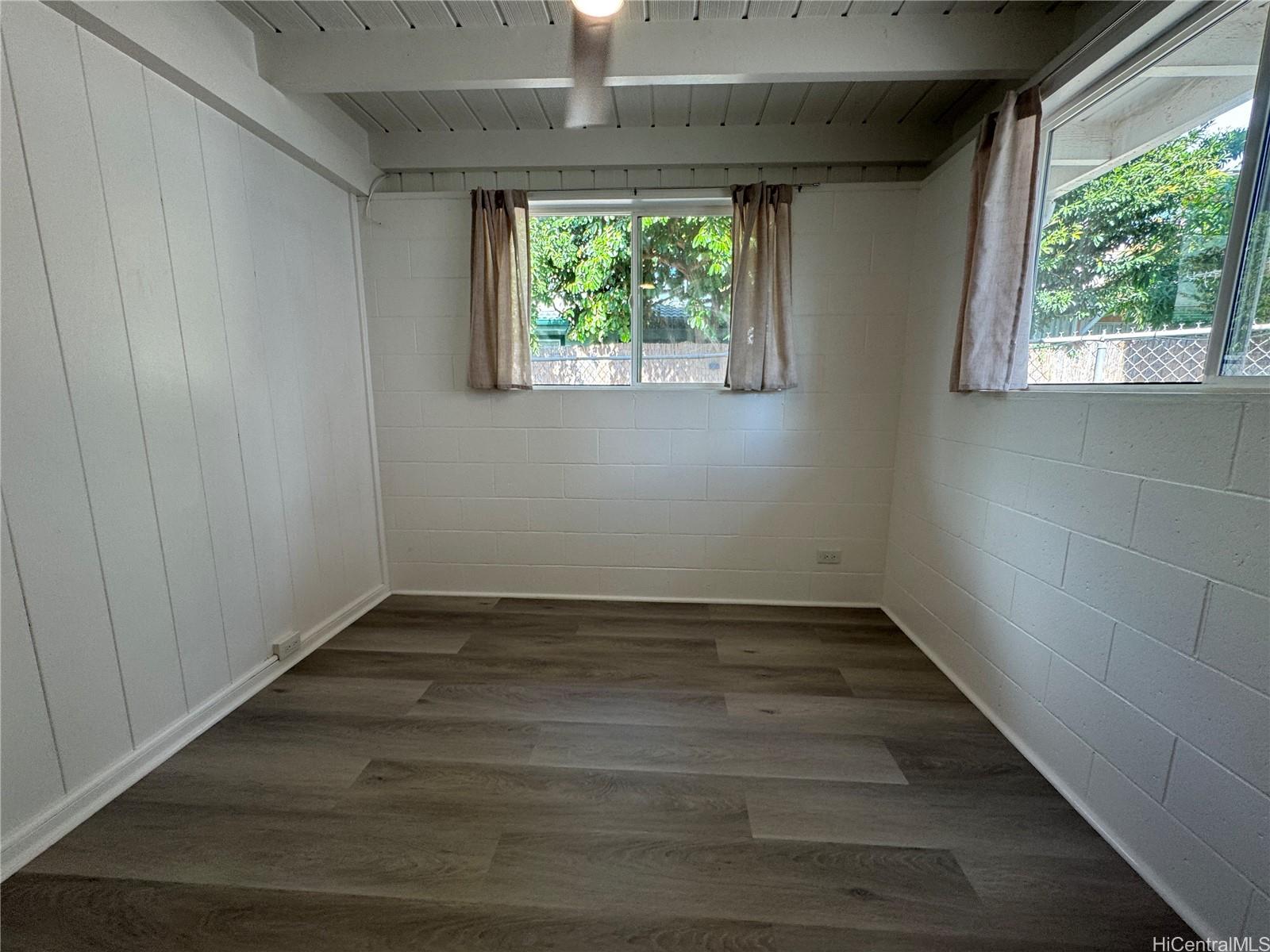 2326 Rose Street Honolulu, HI 96819 - Photo 7 of 19 a view of an empty room with wooden floor and a window