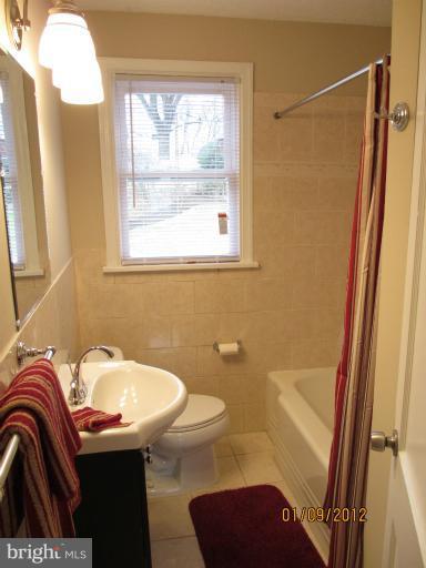 2801 Sheraton Street Silver Spring, MD 20906 - Photo 5 of 15 a bathroom with a sink a toilet and a mirror