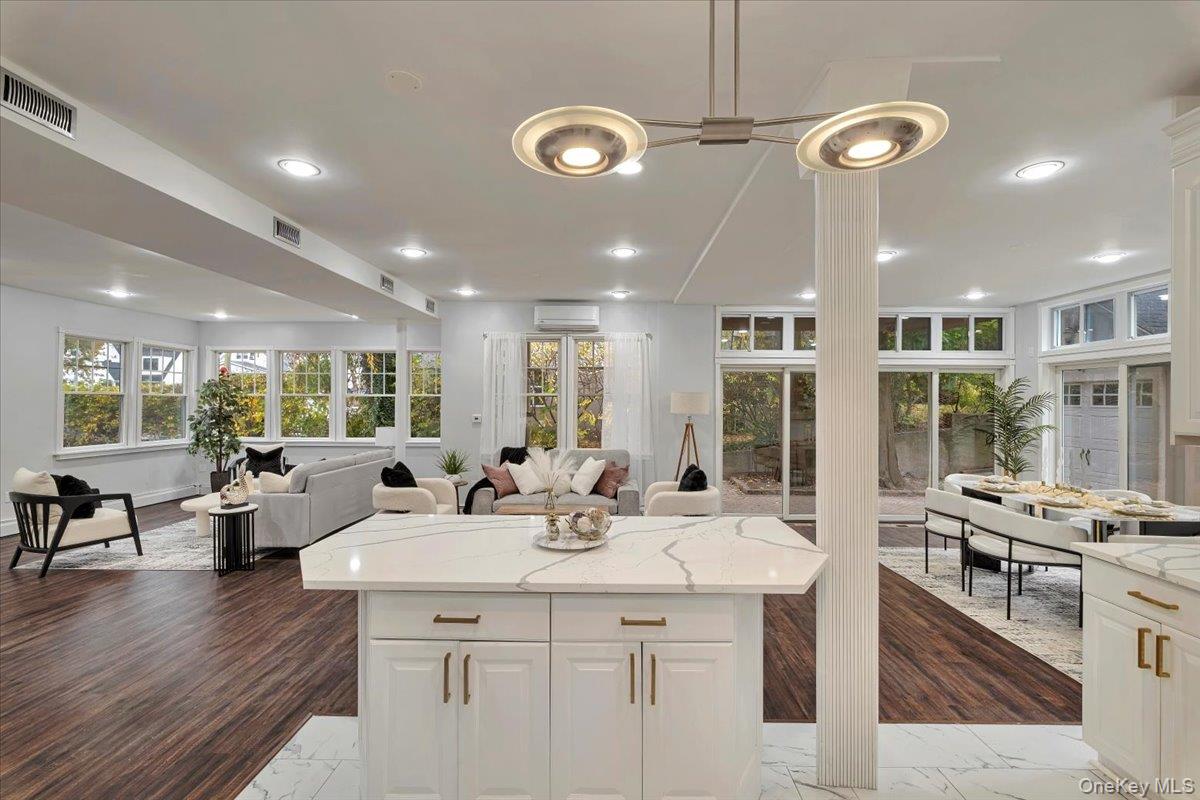 193 Nelson Road Scarsdale, NY 10583 - Photo 10 of 37 a kitchen with stainless steel appliances kitchen island a large window and wooden floor