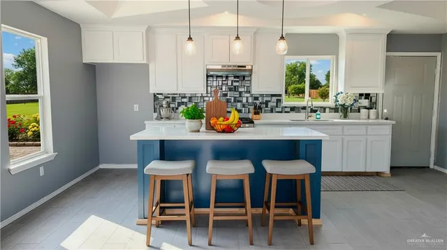 a dining table with stainless steel appliances kitchen island granite countertop furniture and a window