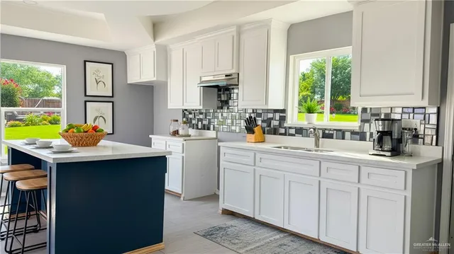 a kitchen with stainless steel appliances a sink a counter top space and a window