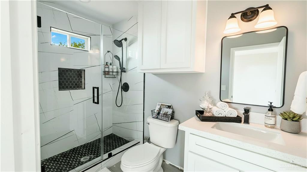 14613 Santa Rita Avenue Mercedes, TX 78570 - Photo 10 of 13 a bathroom with a sink a toilet and shower