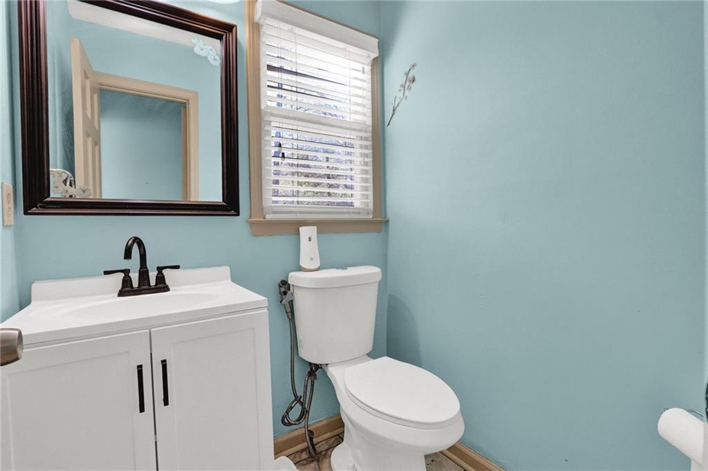 5010 Oak Tree Lane Stone Mountain, GA 30087 - Photo 13 of 35 a bathroom with a toilet sink and mirror