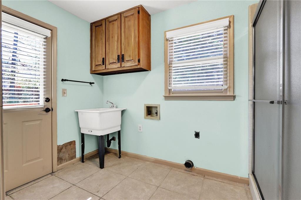 5010 Oak Tree Lane Stone Mountain, GA 30087 - Photo 14 of 35 a bathroom with a sink a mirror and a window