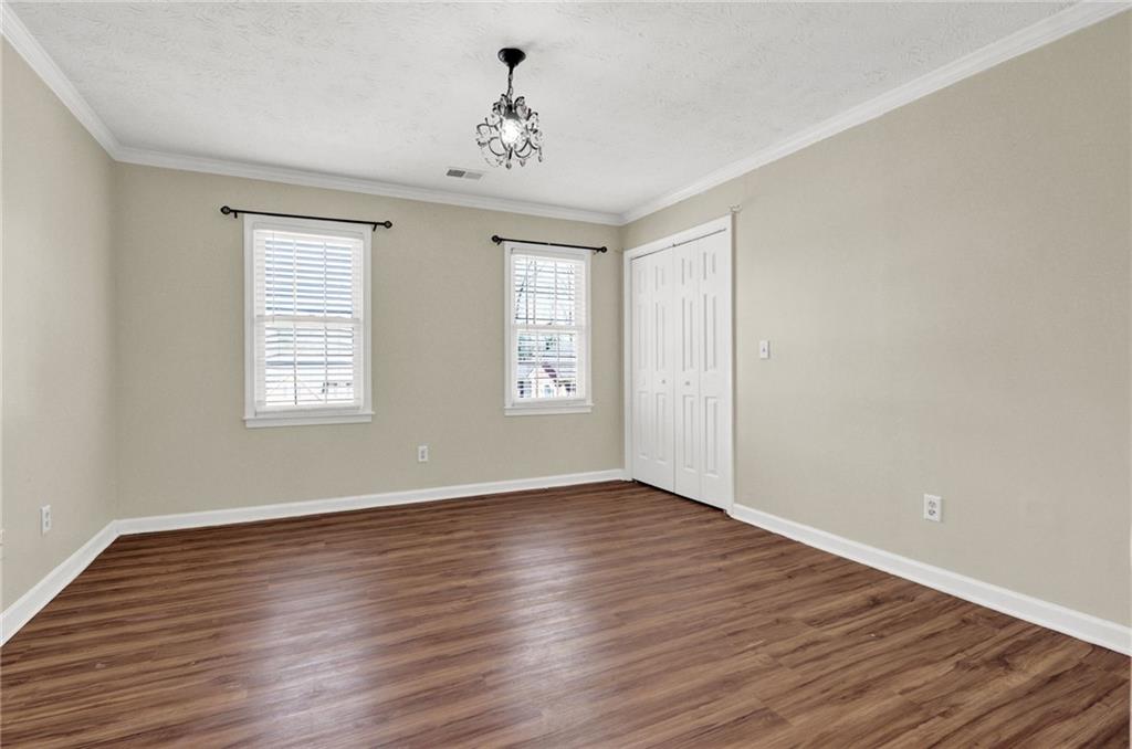 5010 Oak Tree Lane Stone Mountain, GA 30087 - Photo 15 of 35 a view of an empty room with wooden floor and a window