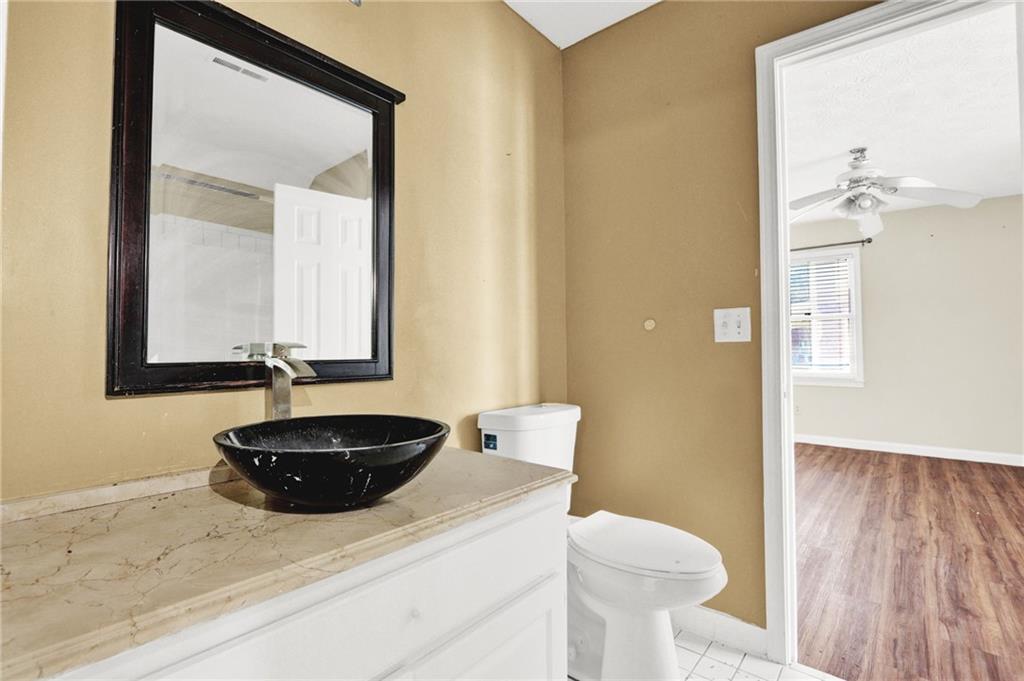5010 Oak Tree Lane Stone Mountain, GA 30087 - Photo 16 of 35 a bathroom with a sink and a mirror