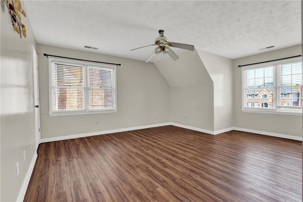 5010 Oak Tree Lane Stone Mountain, GA 30087 - Photo 17 of 35 a view of an empty room with wooden floor and a window