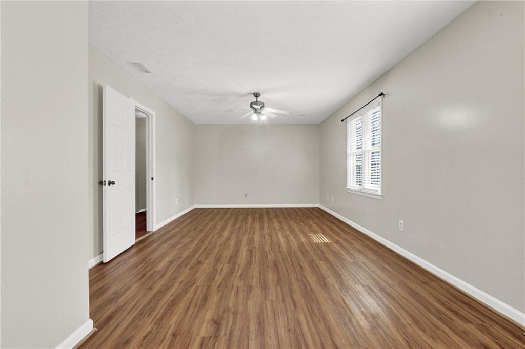 5010 Oak Tree Lane Stone Mountain, GA 30087 - Photo 19 of 35 wooden floor in an empty room with a window
