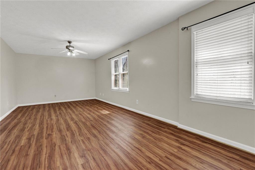 5010 Oak Tree Lane Stone Mountain, GA 30087 - Photo 20 of 35 wooden floor in an empty room with a window