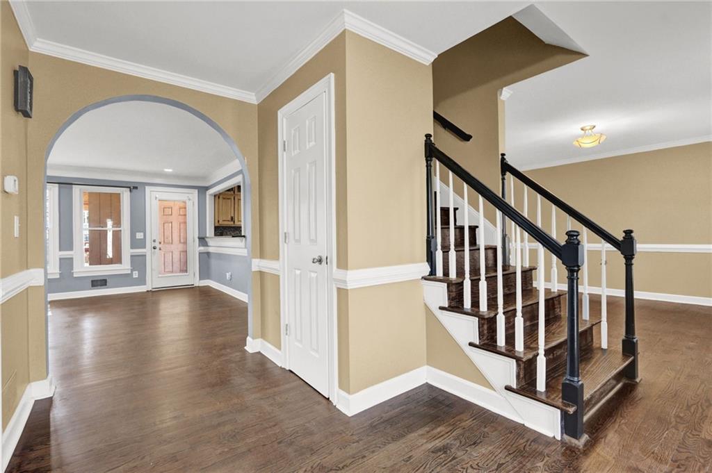 5010 Oak Tree Lane Stone Mountain, GA 30087 - Photo 2 of 35 a view of a livingroom with wooden floor and staircase