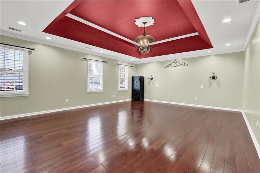 5010 Oak Tree Lane Stone Mountain, GA 30087 - Photo 22 of 35 an empty room with wooden floor and windows