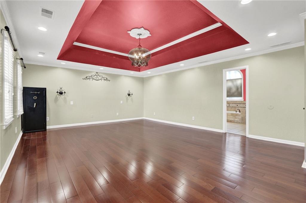 5010 Oak Tree Lane Stone Mountain, GA 30087 - Photo 23 of 35 a view of an empty room with wooden floor