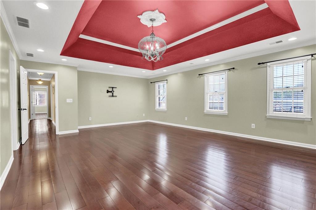 5010 Oak Tree Lane Stone Mountain, GA 30087 - Photo 24 of 35 a view of an empty room with wooden floor and a window