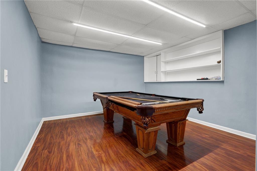 5010 Oak Tree Lane Stone Mountain, GA 30087 - Photo 28 of 35 a room with wooden floor and pool table