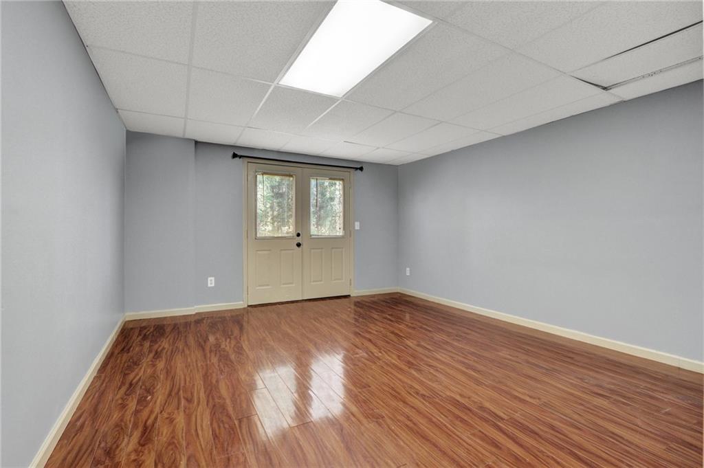 5010 Oak Tree Lane Stone Mountain, GA 30087 - Photo 29 of 35 wooden floor in an empty room with a window