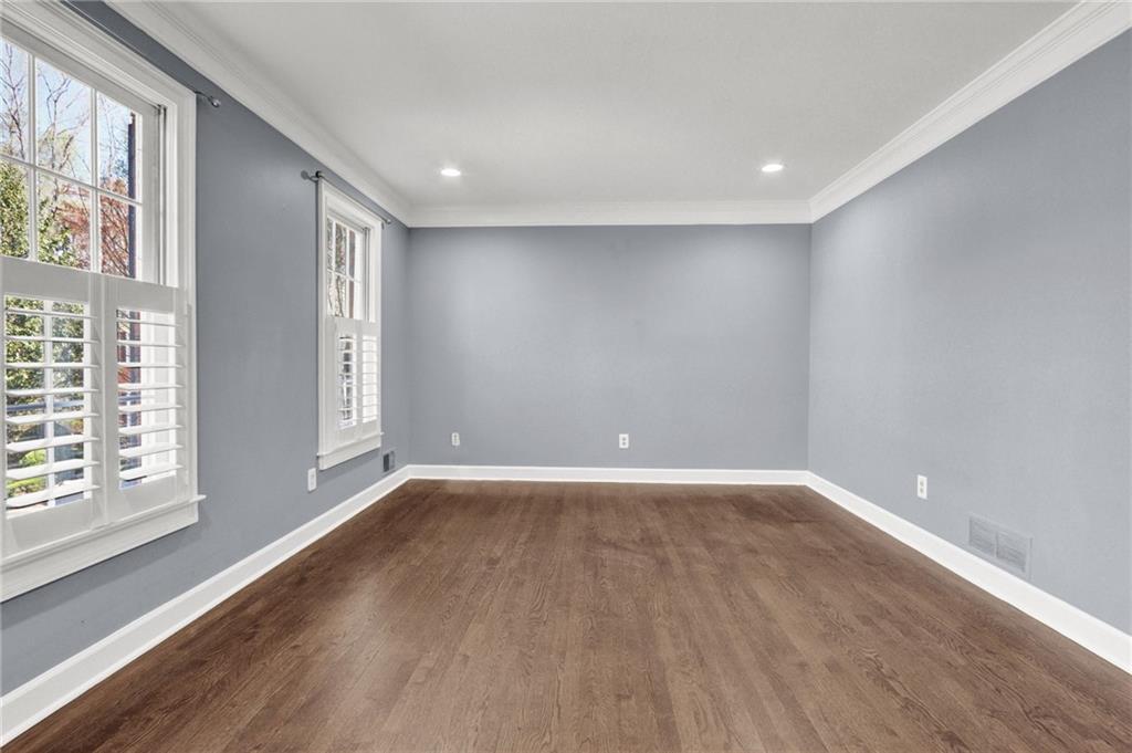 5010 Oak Tree Lane Stone Mountain, GA 30087 - Photo 3 of 35 a view of an empty room with wooden floor and a window