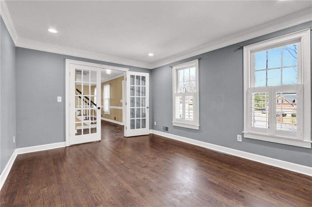 5010 Oak Tree Lane Stone Mountain, GA 30087 - Photo 4 of 35 a view of an empty room with wooden floor and a window