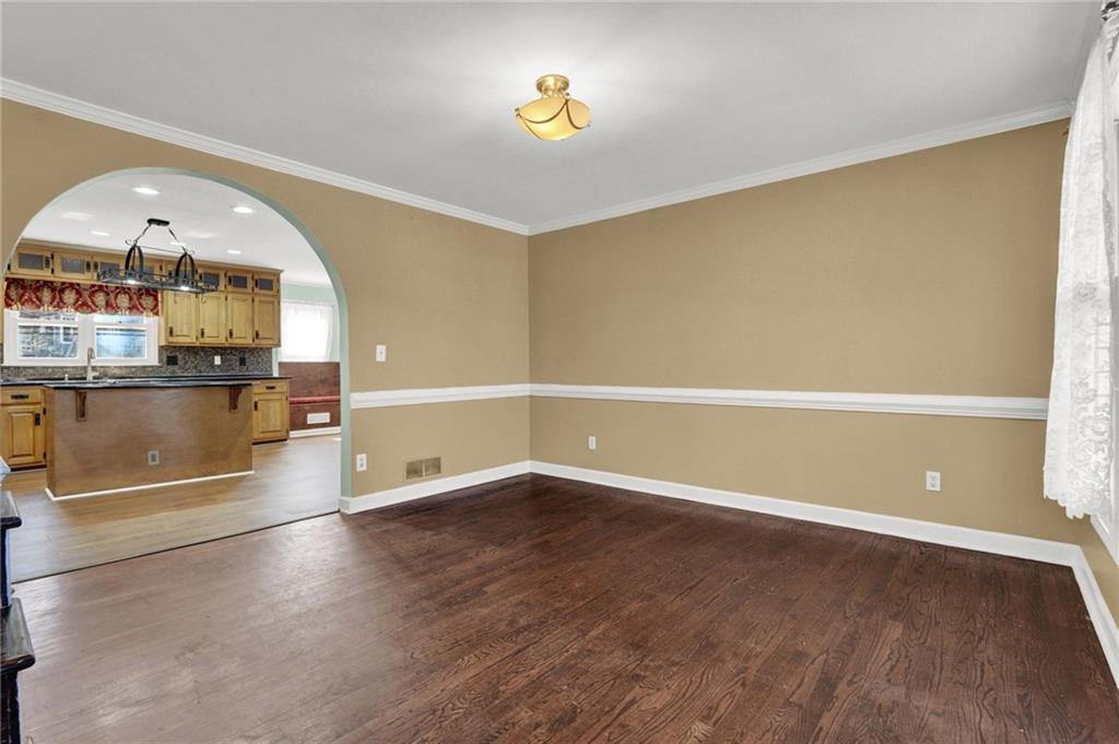 5010 Oak Tree Lane Stone Mountain, GA 30087 - Photo 5 of 35 wooden floor in an empty room with a window