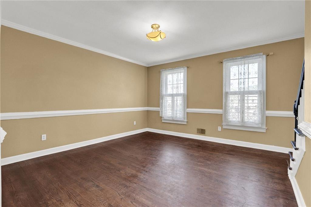 5010 Oak Tree Lane Stone Mountain, GA 30087 - Photo 6 of 35 an empty room with wooden floor and windows