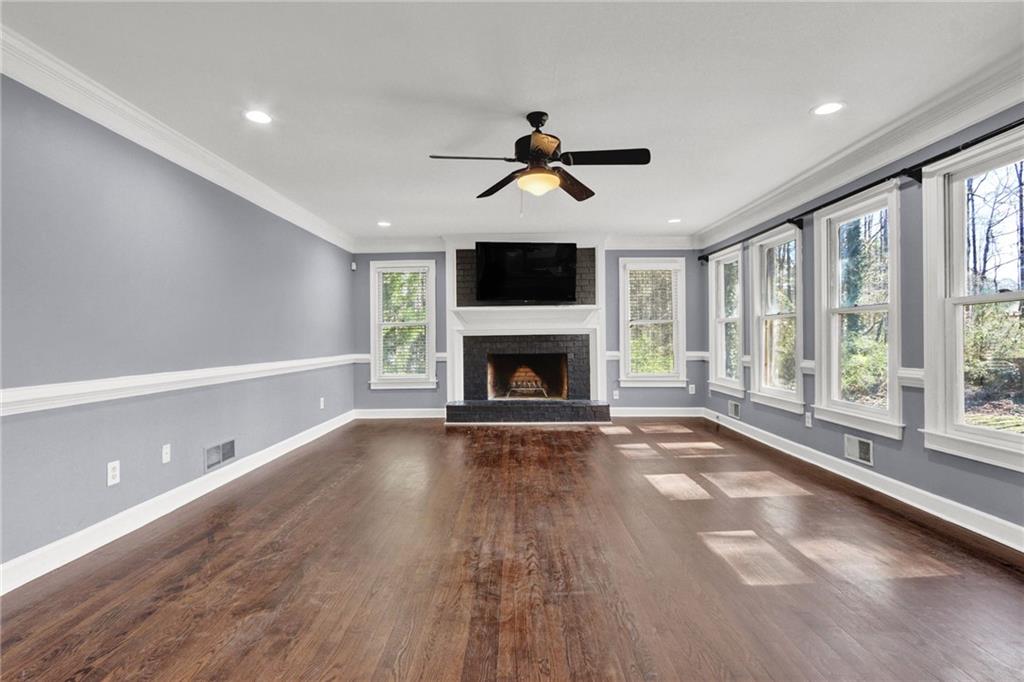 5010 Oak Tree Lane Stone Mountain, GA 30087 - Photo 7 of 35 a view of empty room with wooden floor and fireplace