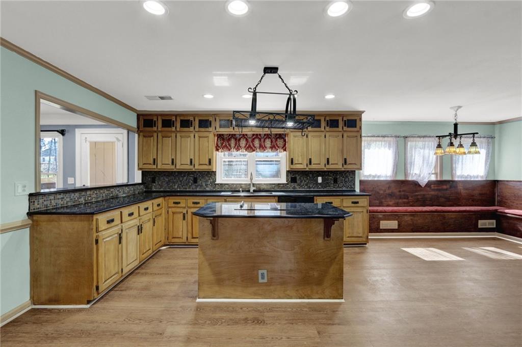 5010 Oak Tree Lane Stone Mountain, GA 30087 - Photo 10 of 35 a kitchen with stainless steel appliances granite countertop a stove a sink and a granite island