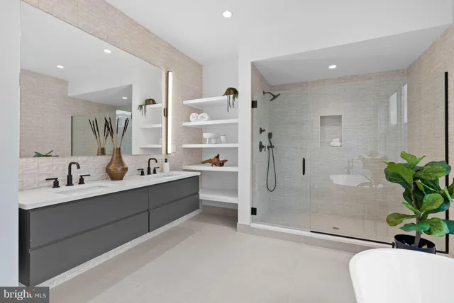 a large bathroom with a double vanity sink toilet and shower