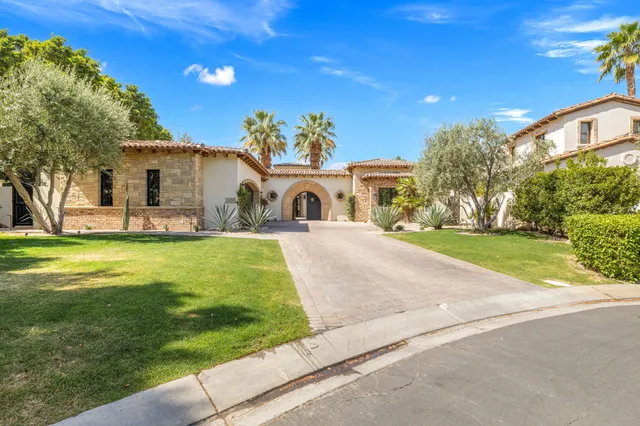 a kitchen with stainless steel appliances white cabinets and a stove top oven