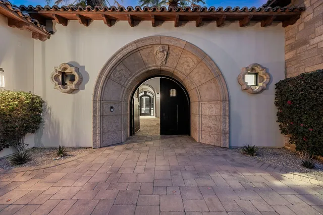 a bedroom with a bed and a flat tv screen on dresser