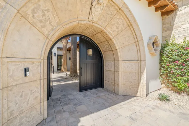 a bathroom with a granite countertop sink a mirror and a shower