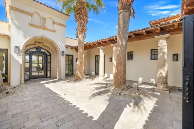 a bedroom with a large bed and a painting on the wall
