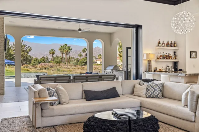 a view of living room with furniture and a large window