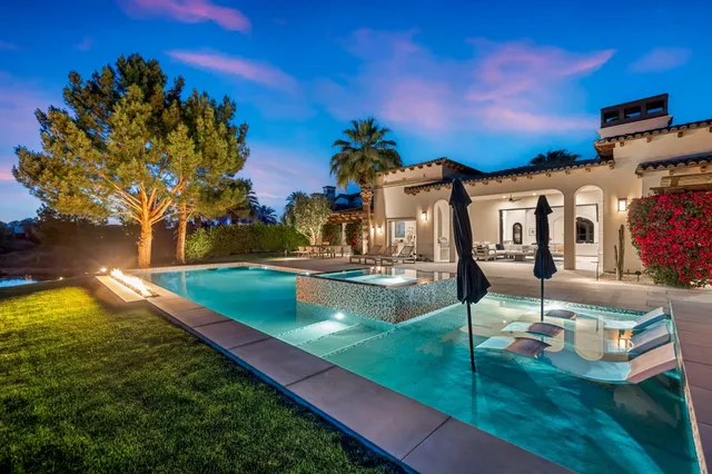 a front view of a house with a garden and yard