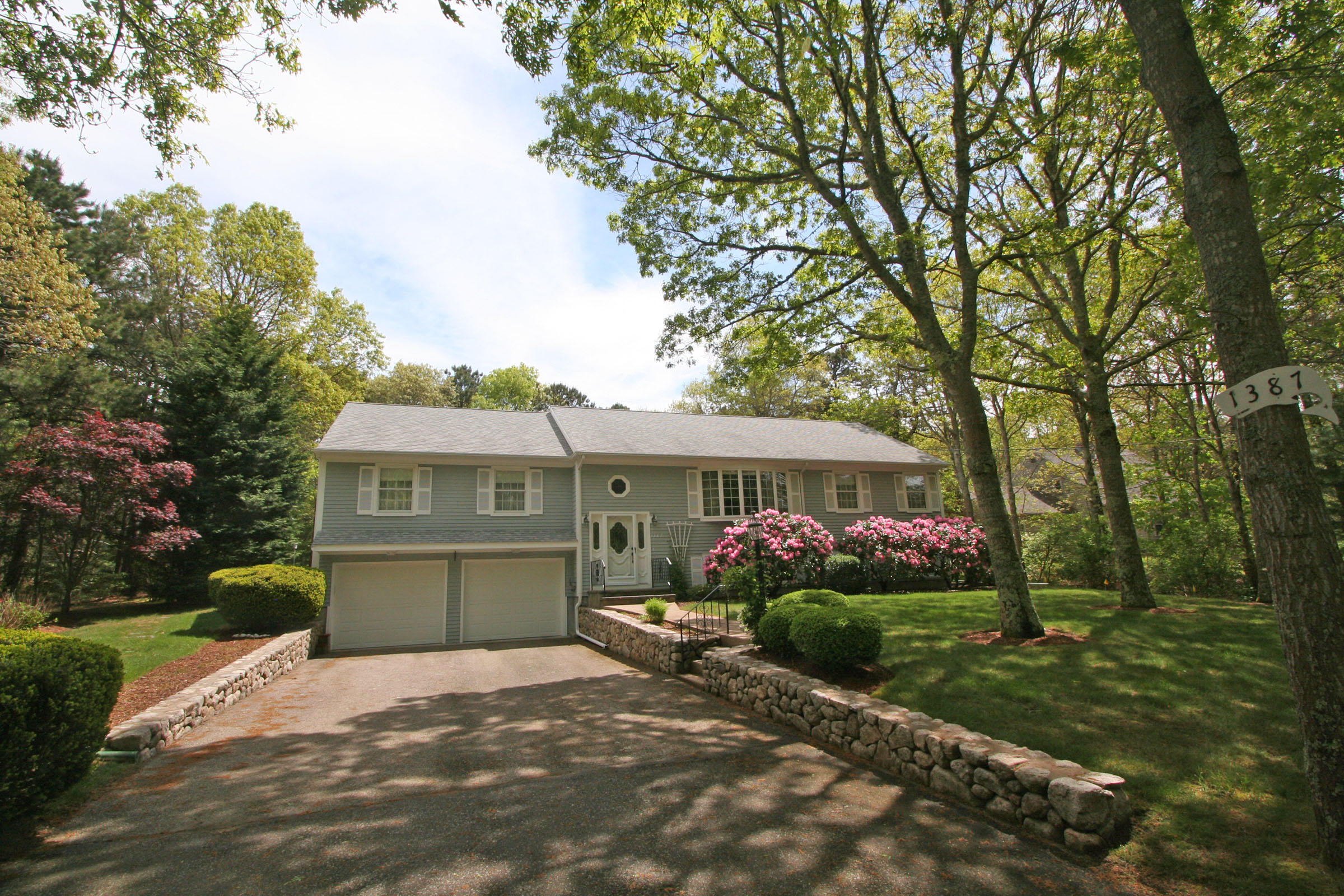 1387 Old Post Road Marstons Mills, MA 02648 - Photo 1 of 22 a front view of a house with garden