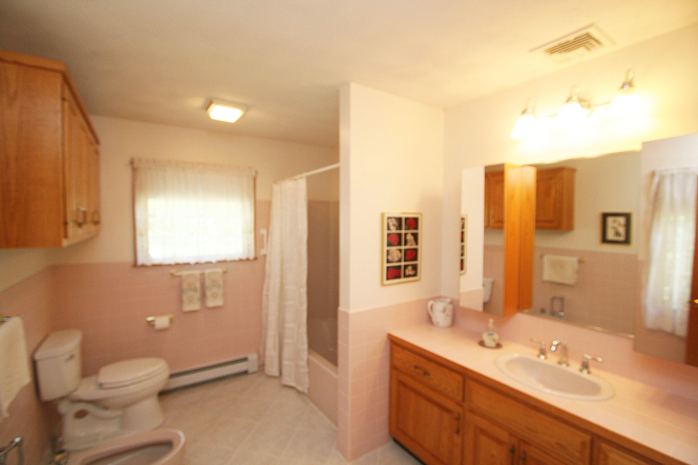 1387 Old Post Road Marstons Mills, MA 02648 - Photo 18 of 22 a bathroom with a double vanity sink toilet and a mirror