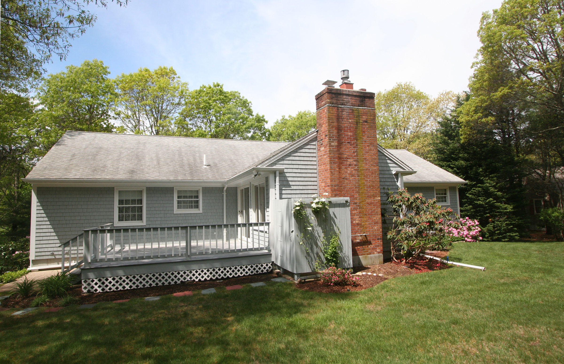 1387 Old Post Road Marstons Mills, MA 02648 - Photo 3 of 22 a front view of a house with a garden