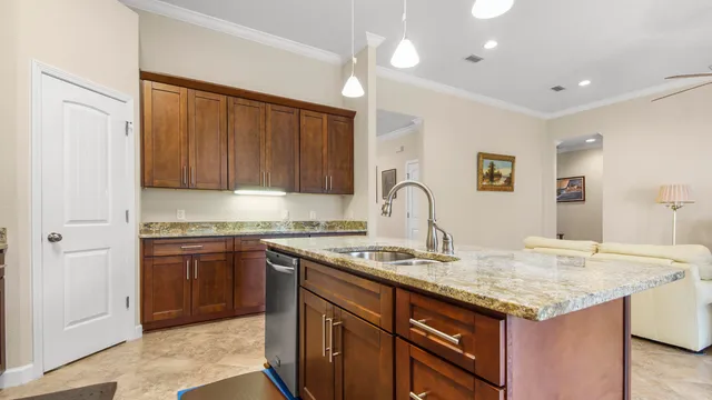 a kitchen with granite countertop cabinets stainless steel appliances and a counter space