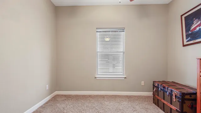 a room that has a window and a dresser in it