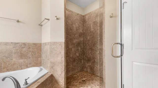 a bathroom with a granite countertop bathtub shower and sink