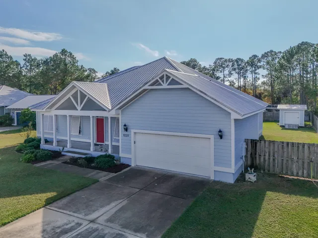 a view of a house with a yard and garage