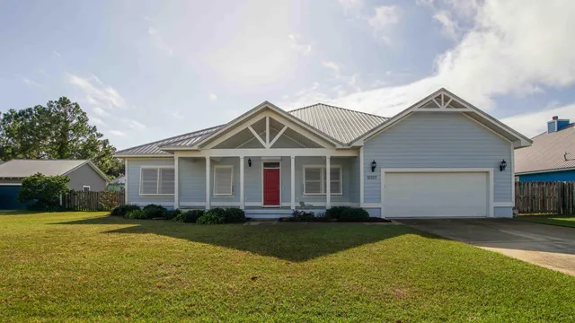 a front view of a house with yard and green space
