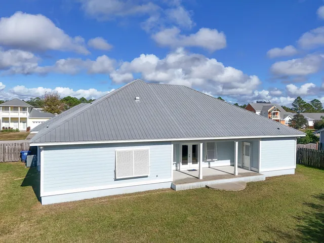 a backyard of a house with table and chairs