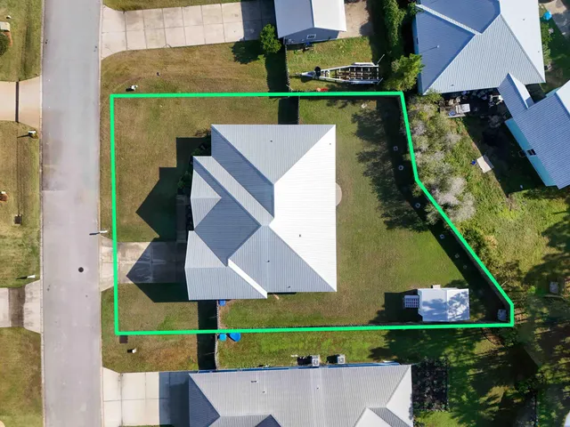 an aerial view of a house with pool outdoor seating and yard