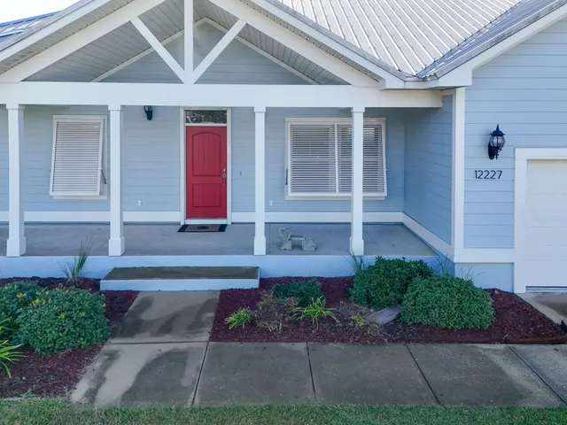 a front view of a house with a yard and a garage