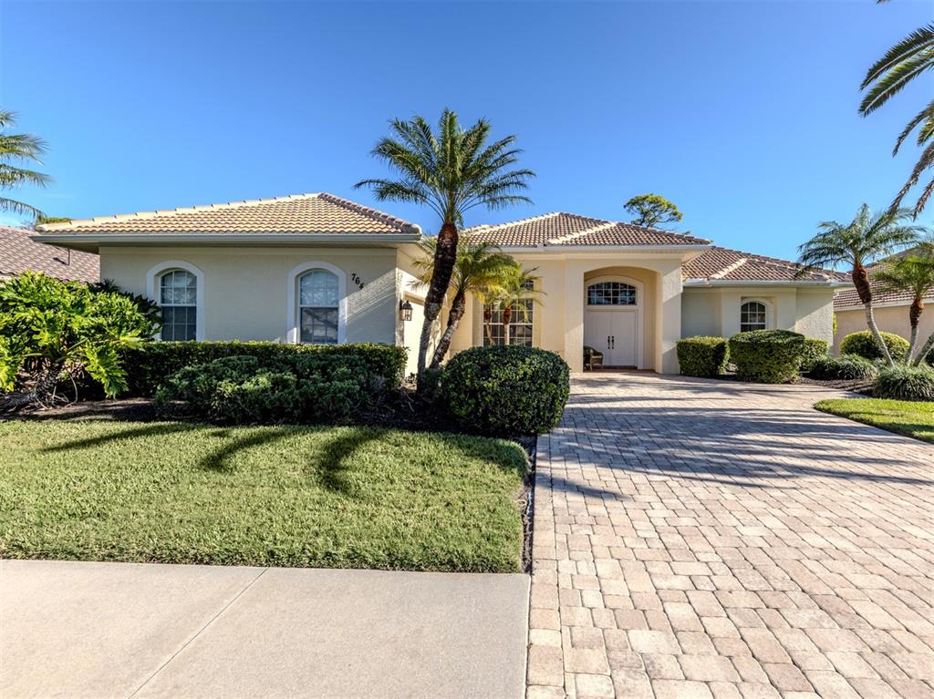 764 Sawgrass Bridge Road Venice, FL 34292 - Photo 1 of 60 a front view of a house with a yard