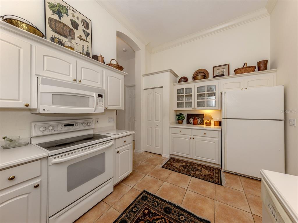 764 Sawgrass Bridge Road Venice, FL 34292 - Photo 11 of 60 a kitchen with a stove a sink and a refrigerator