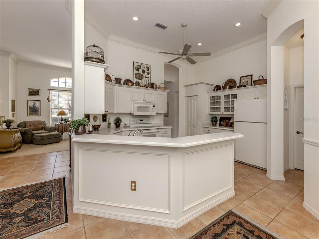 764 Sawgrass Bridge Road Venice, FL 34292 - Photo 12 of 60 a kitchen with stainless steel appliances granite countertop a sink stove and refrigerator